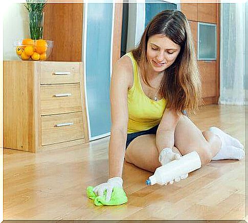 Woman cleans wooden floors